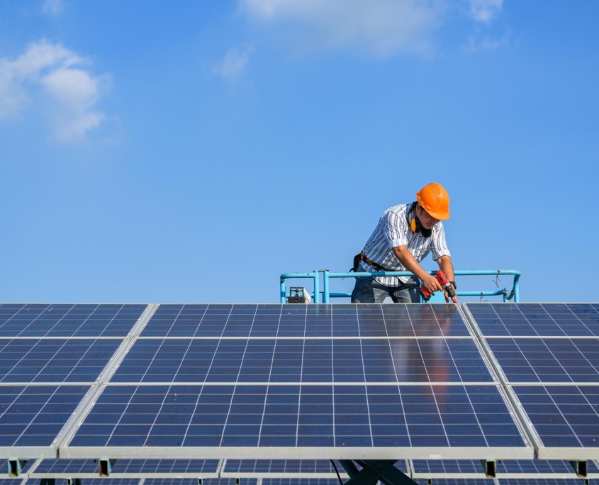 Front view of a man installing solar panels